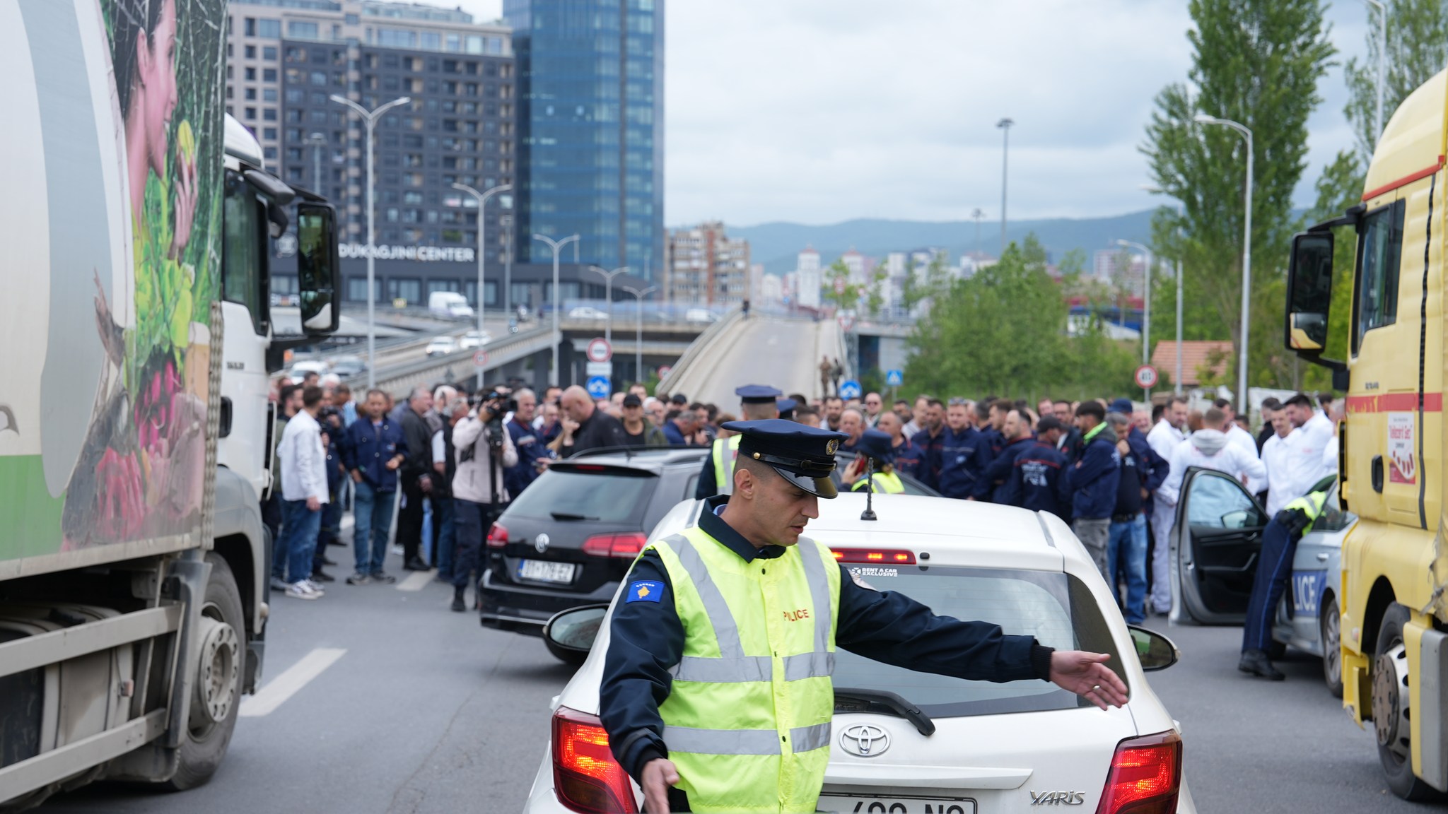 May be an image of 6 people, ambulance, car, crowd, road and text